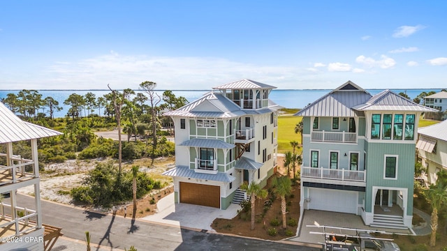 view of front of house with a garage and a water view