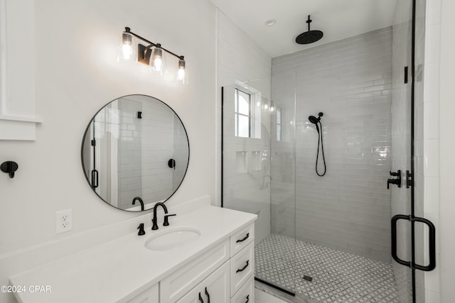 bathroom with vanity and a shower with door