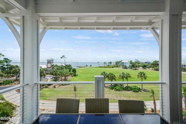 unfurnished sunroom featuring a water view