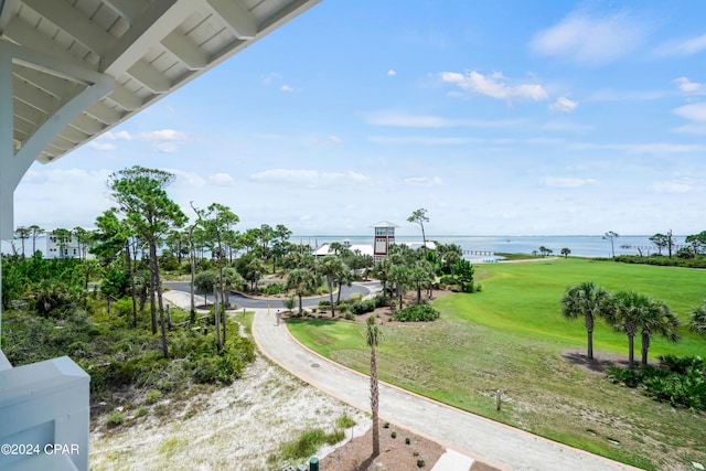 view of property's community featuring a lawn and a water view