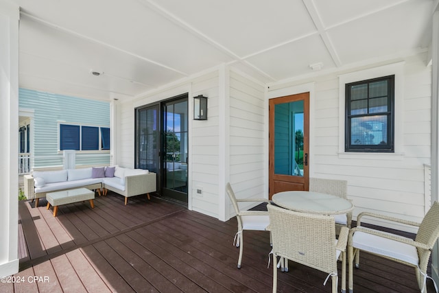 deck featuring covered porch and an outdoor hangout area