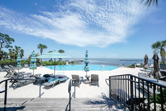 view of swimming pool with a water view