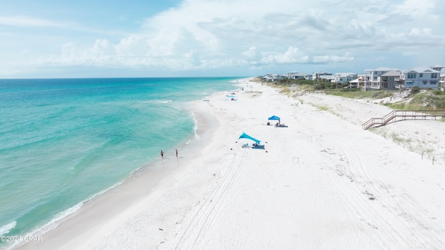 drone / aerial view with a water view and a beach view