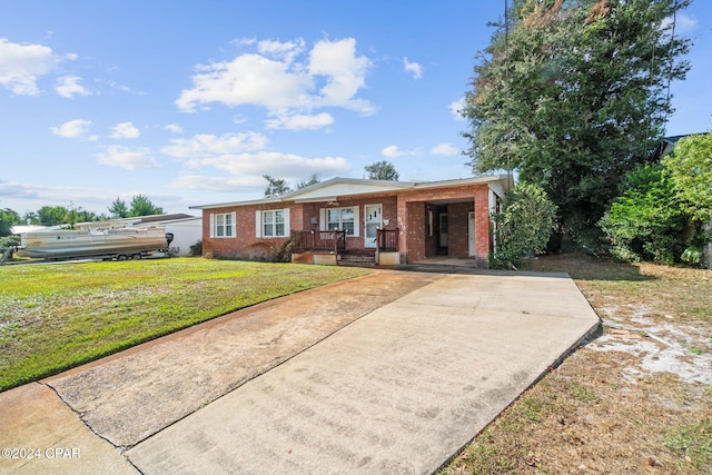 ranch-style house with a front yard and a carport