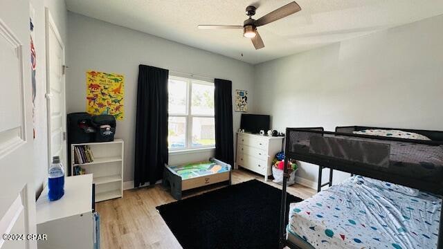 bedroom with ceiling fan and light hardwood / wood-style flooring