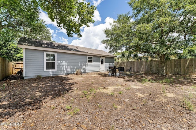 back of property featuring a fenced backyard and a patio