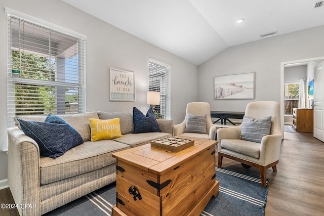 living area with lofted ceiling, visible vents, wood finished floors, and recessed lighting