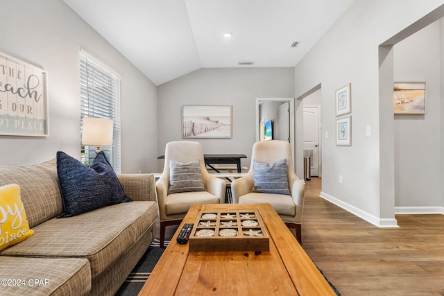 living room featuring lofted ceiling, recessed lighting, wood finished floors, visible vents, and baseboards