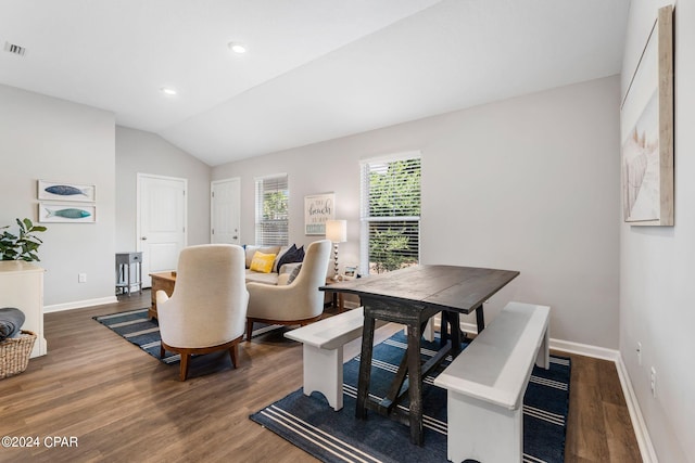 dining room with lofted ceiling, recessed lighting, wood finished floors, and baseboards