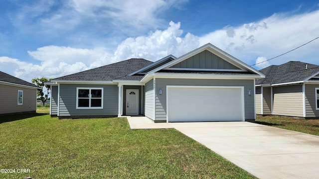 view of front of home featuring a garage and a front yard