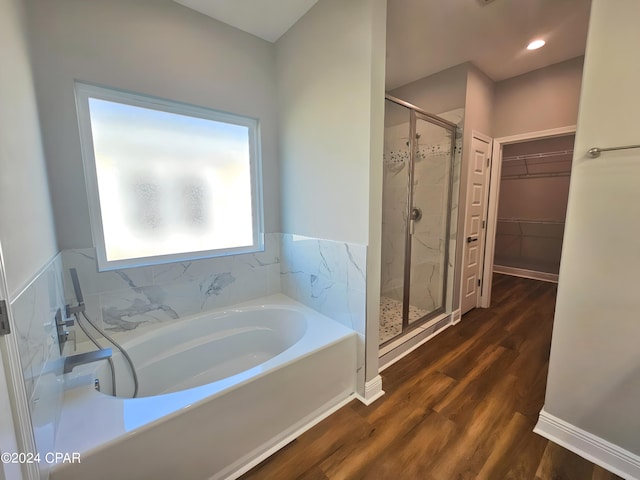 bathroom with plus walk in shower and hardwood / wood-style floors