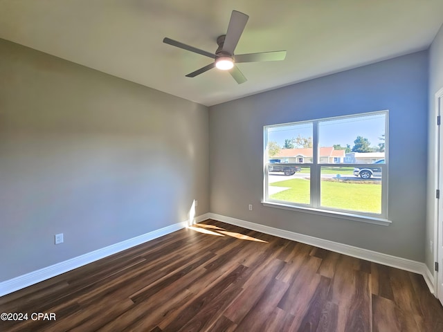 unfurnished room featuring ceiling fan and dark wood-type flooring