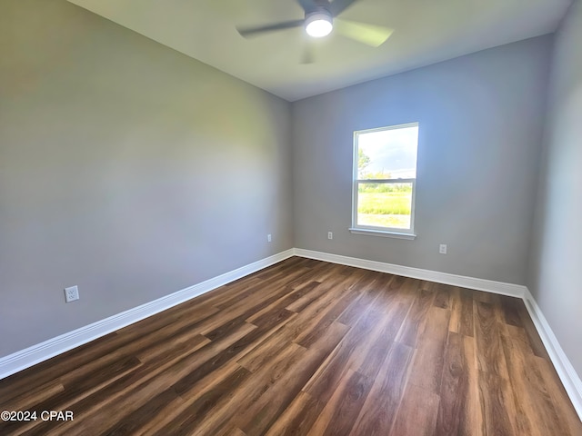 unfurnished room featuring ceiling fan and dark hardwood / wood-style flooring