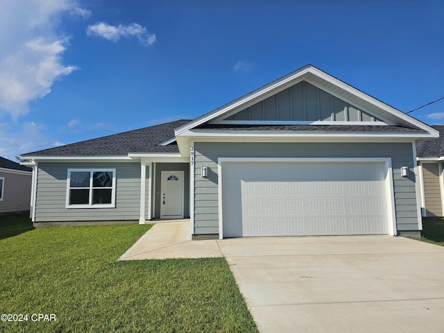 view of front of house featuring a garage and a front yard