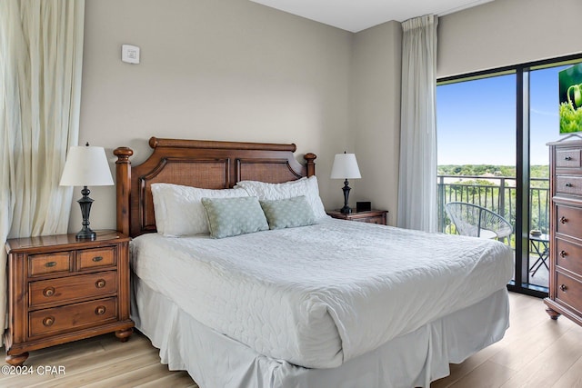 bedroom with access to exterior and light wood-type flooring