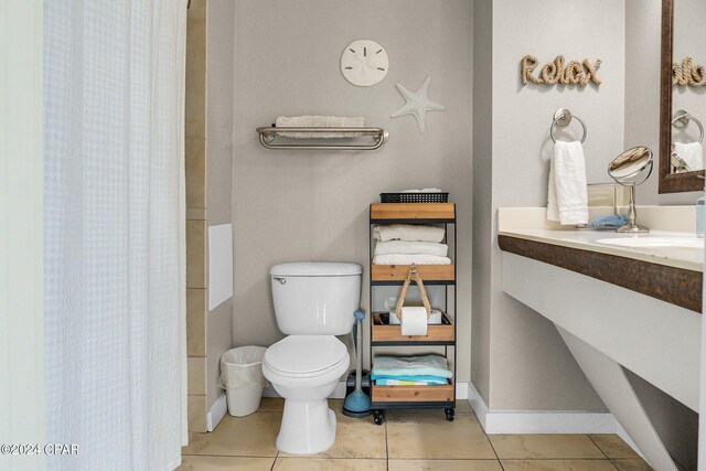 bathroom with tile patterned flooring, toilet, and vanity