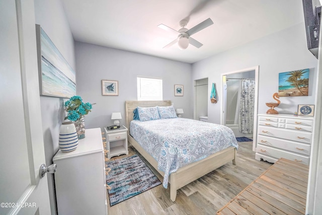 bedroom featuring ensuite bath, light wood-type flooring, and ceiling fan