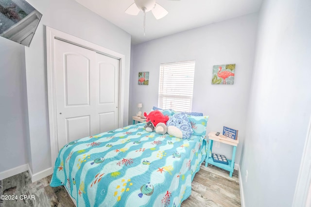 bedroom featuring ceiling fan, light wood-type flooring, and a closet