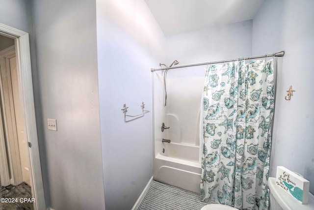 bathroom featuring tile patterned floors, shower / bath combo with shower curtain, and toilet