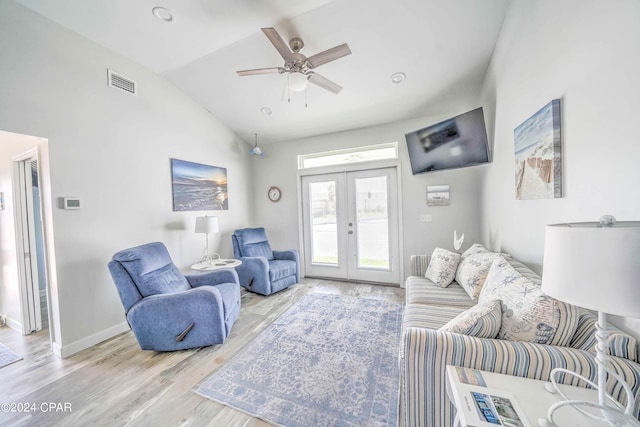 living room featuring light hardwood / wood-style flooring, french doors, high vaulted ceiling, and ceiling fan