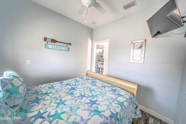 bedroom with hardwood / wood-style flooring and ceiling fan