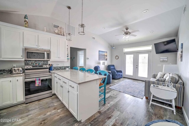 kitchen featuring white cabinetry, kitchen peninsula, hardwood / wood-style flooring, and range with electric stovetop