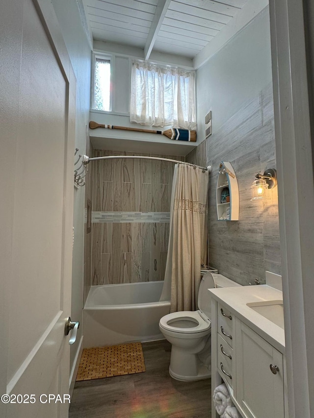 full bathroom featuring vanity, wood finished floors, shower / bathtub combination with curtain, beam ceiling, and toilet