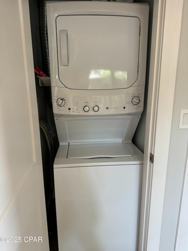 washroom with laundry area and stacked washer / dryer