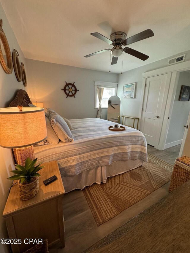 bedroom with ceiling fan and a closet