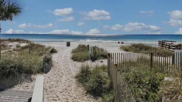 water view featuring a view of the beach and fence