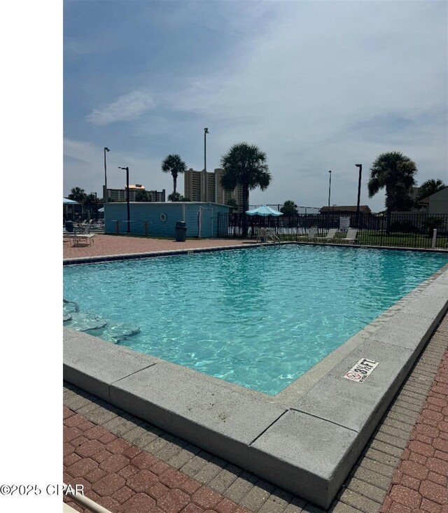 view of pool with a patio area and a yard