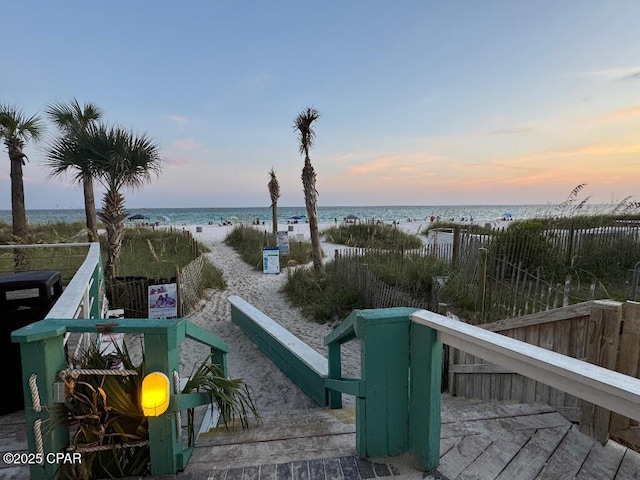 view of yard with a beach view and a water view