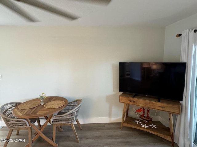 dining room featuring wood finished floors and baseboards