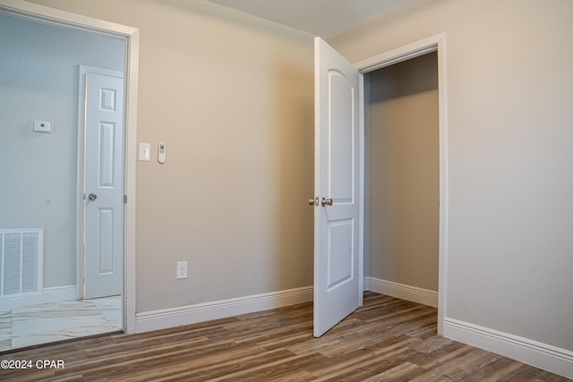 empty room with plenty of natural light and dark hardwood / wood-style flooring