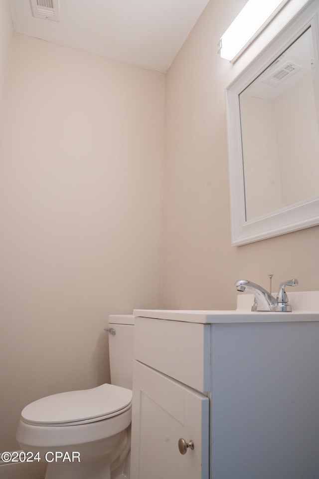 bathroom with toilet and vanity