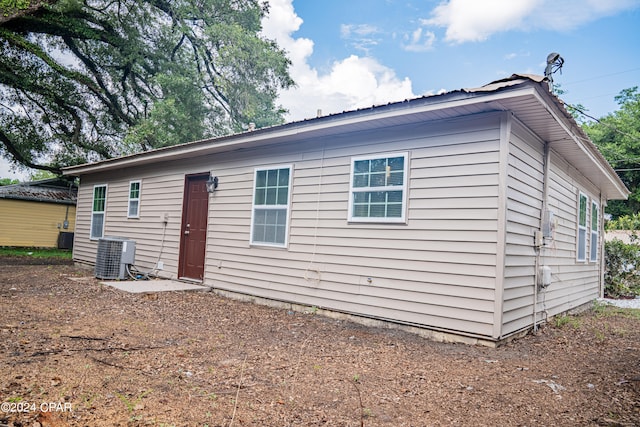 back of property featuring central AC