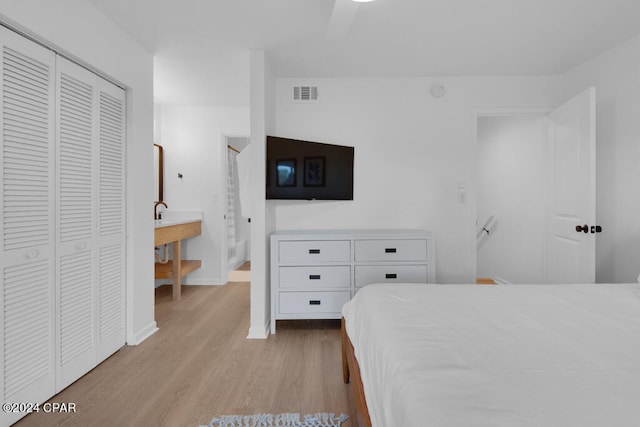 bedroom featuring a closet, light wood-type flooring, and ceiling fan