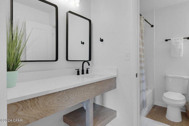 full bathroom featuring sink, shower / bath combo, hardwood / wood-style flooring, and toilet