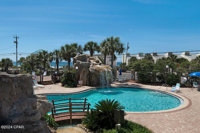 view of pool featuring pool water feature and a patio area