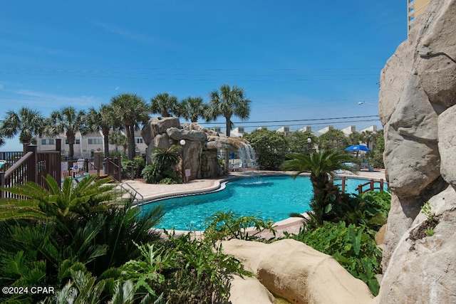 view of swimming pool featuring pool water feature