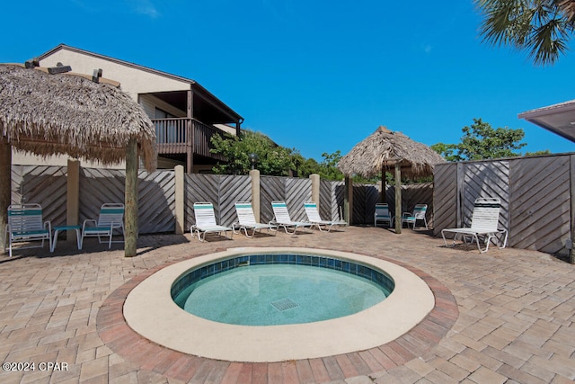 view of swimming pool featuring a patio and a community hot tub