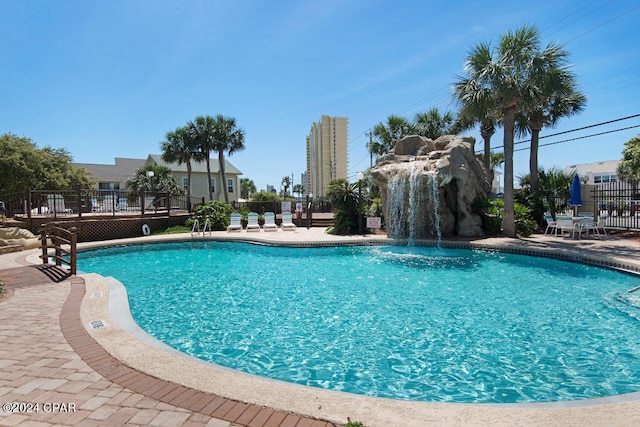 view of swimming pool with a patio area and pool water feature