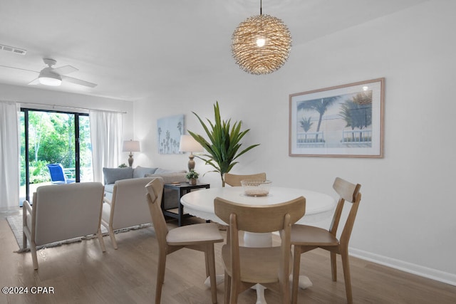 dining room with hardwood / wood-style floors and ceiling fan