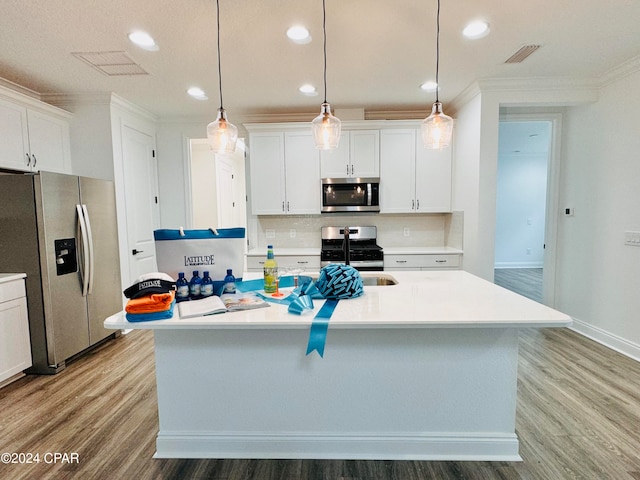 kitchen with a center island with sink, appliances with stainless steel finishes, light wood-type flooring, and white cabinets