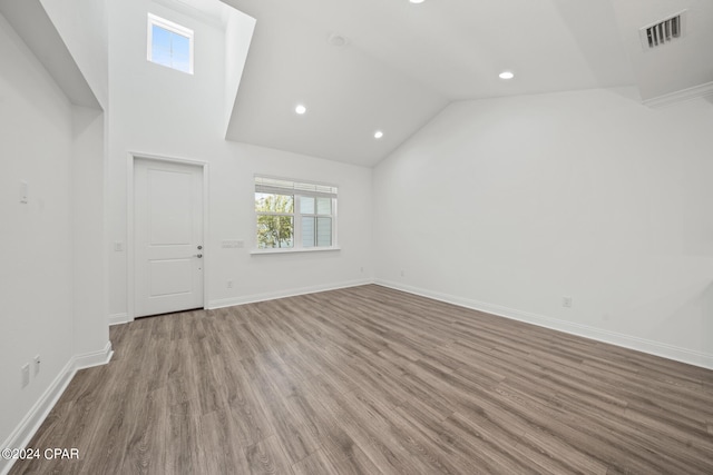 interior space with wood-type flooring and high vaulted ceiling