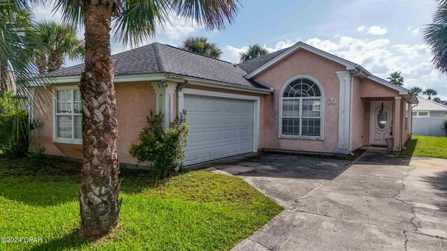 single story home with a garage and a front yard