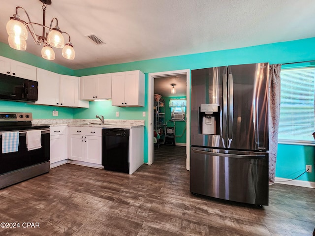 kitchen with hanging light fixtures, white cabinetry, black appliances, and sink