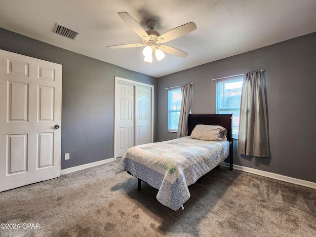 carpeted bedroom with a closet and ceiling fan