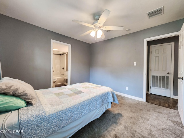 bedroom featuring ceiling fan, ensuite bath, and carpet flooring