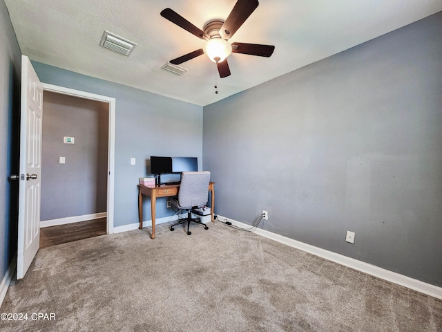 carpeted office space featuring ceiling fan